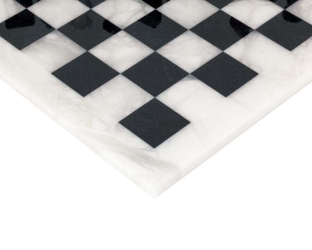 Close-up of black and white alabaster chessboard corner showing natural textures and high sheen finish. Made in Italy.