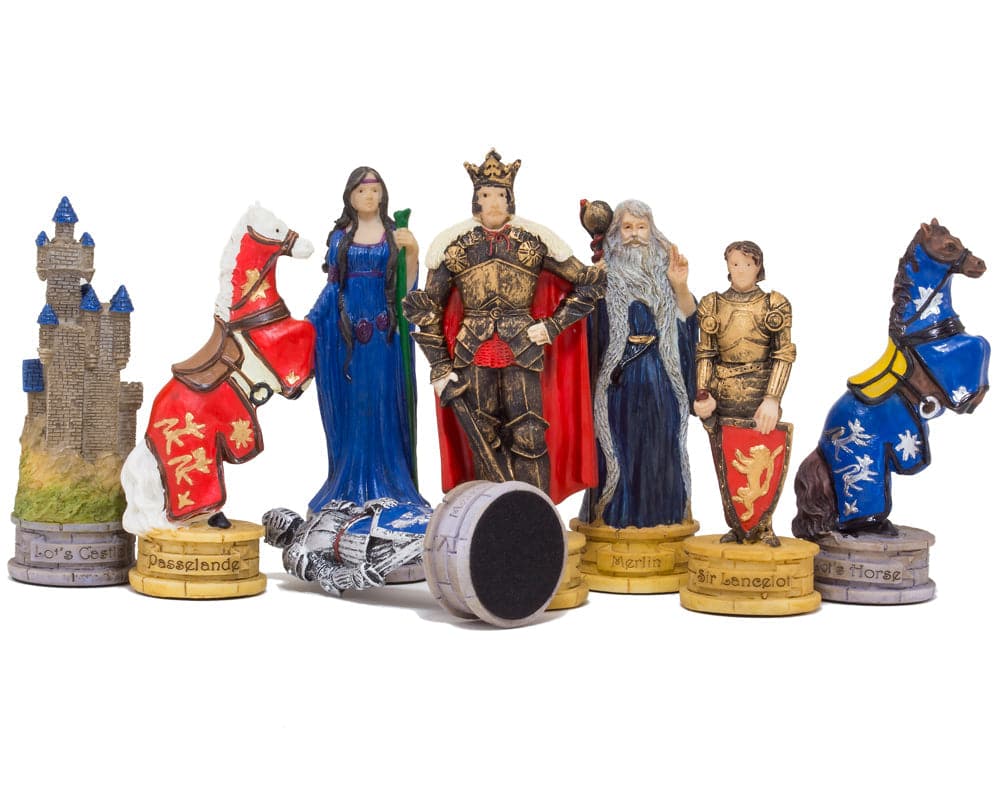 Medieval chess pieces featuring detailed characters and horses, including knights, Merlin the wizard, and a fallen king.