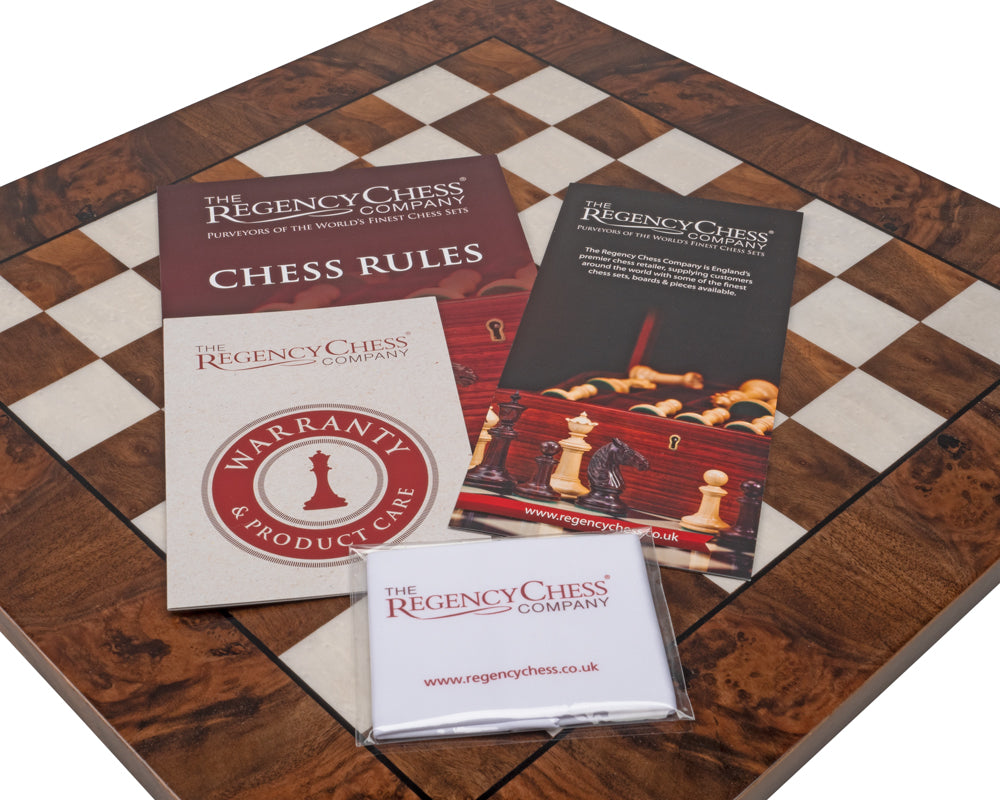 Regency Chess Company luxury chess board with chess rules, warranty, and product care brochures.