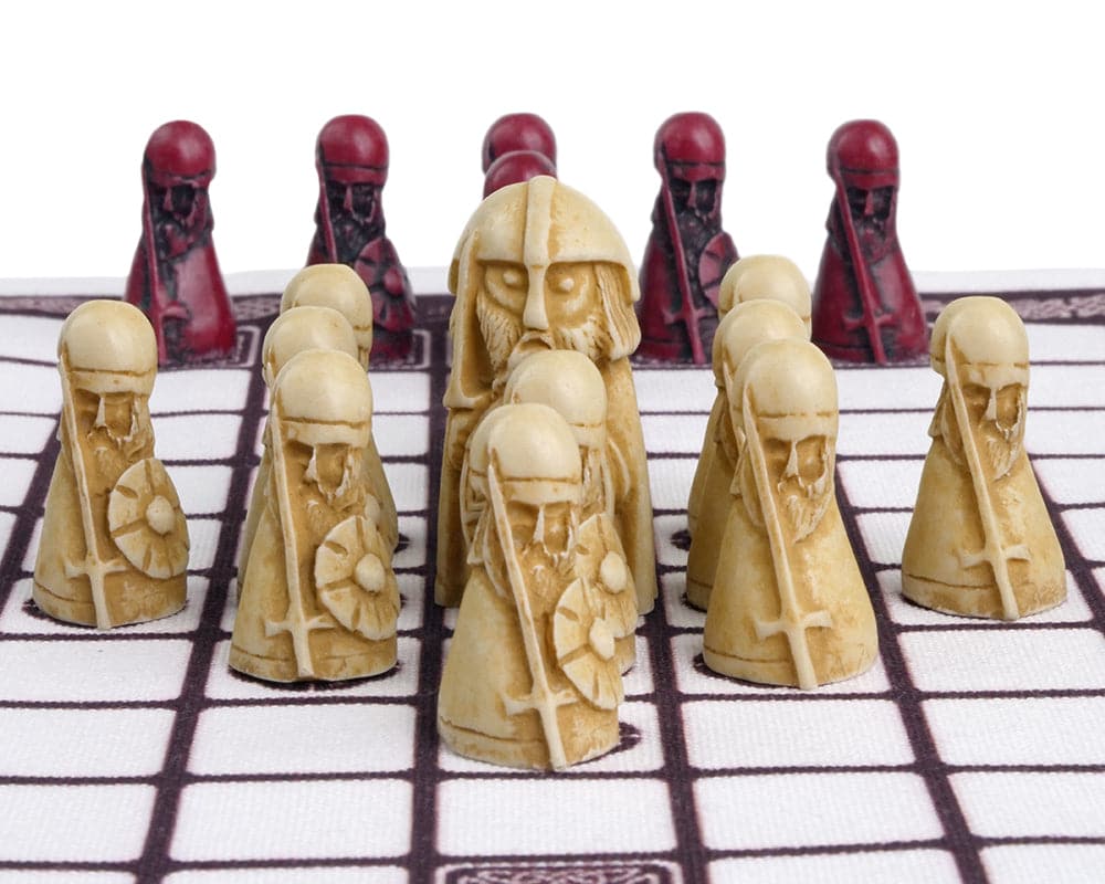 Hnefatafl - The Viking Game - Cardinal Edition playing pieces on screen-printed linen surface with white defenders and red attackers.