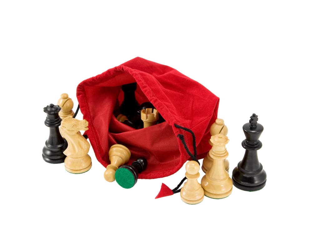 Red drawstring chess piece bag with chess pieces scattered around, made from plush red corded fabric and featuring color coordinated tassels.