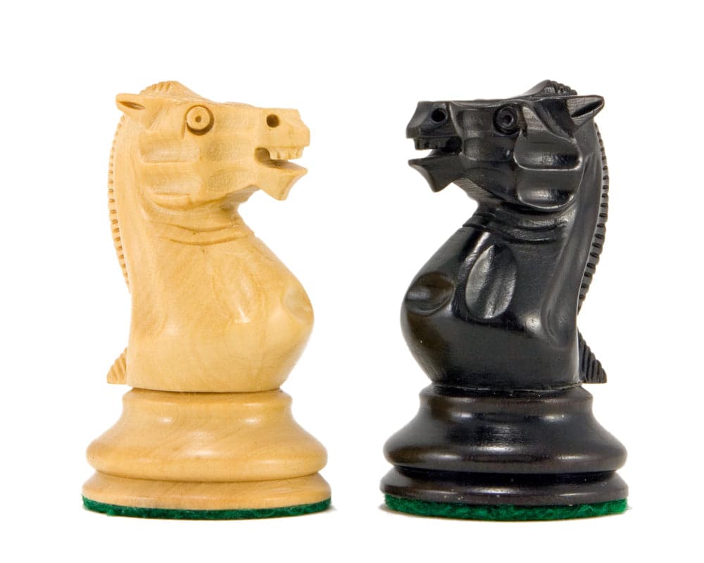 Close-up of two knight chess pieces from the Old English Elite Staunton Chess Set, one in natural wood and one in ebony.