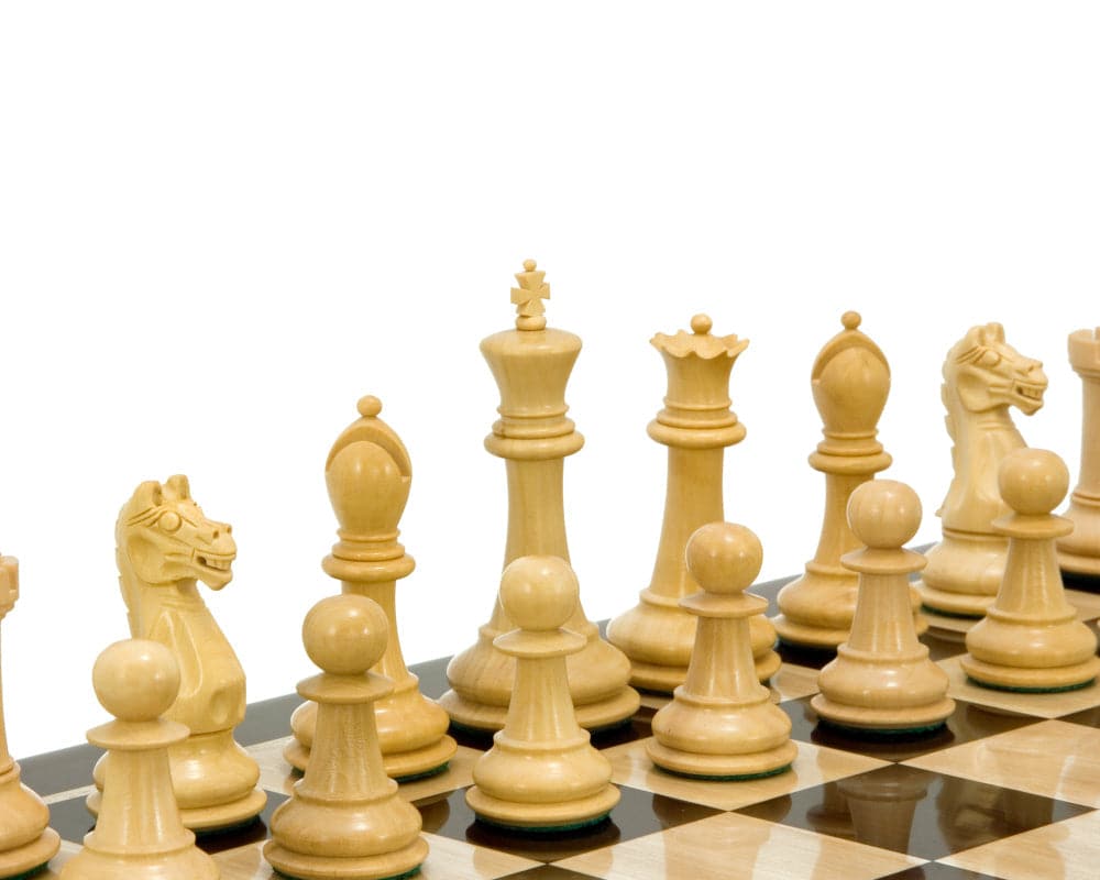 Ebonised boxwood and natural boxwood chessmen set on a chessboard, showcasing the intricate hand-crafted details.