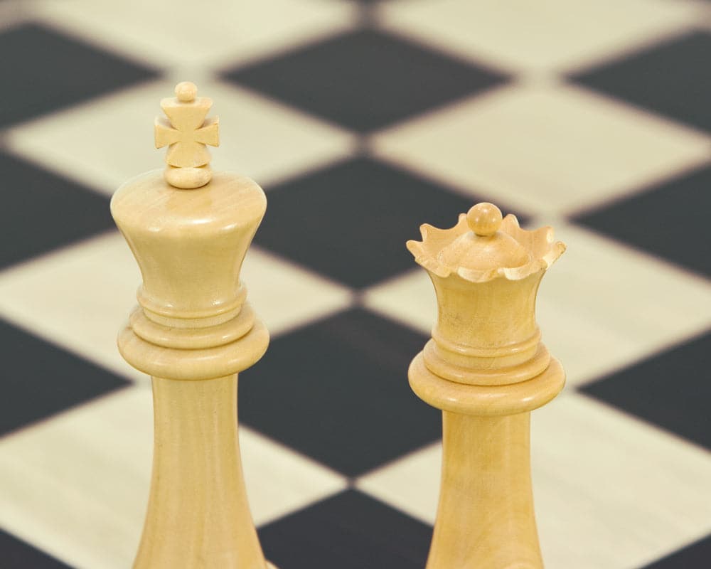 Hand crafted Oxford Series Ebonised Boxwood Chess Pieces on chessboard, showing 3.75 inch king and queen, weighted and felted.