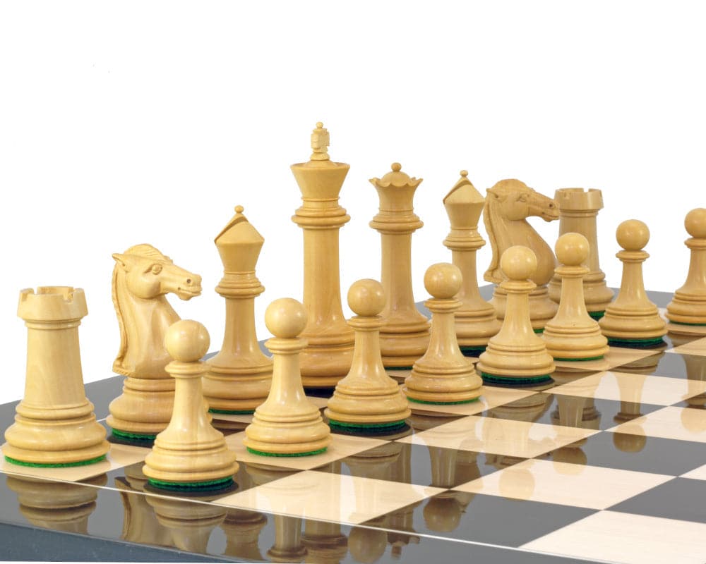 Boxwood chess pieces from the Parthenon Series arranged on a chessboard, featuring a 4.5-inch king and additional queens.