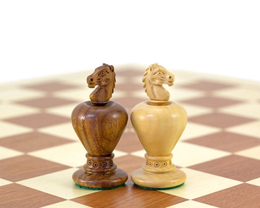 Golden rosewood and boxwood chess knights from the Apple Series on a chessboard.