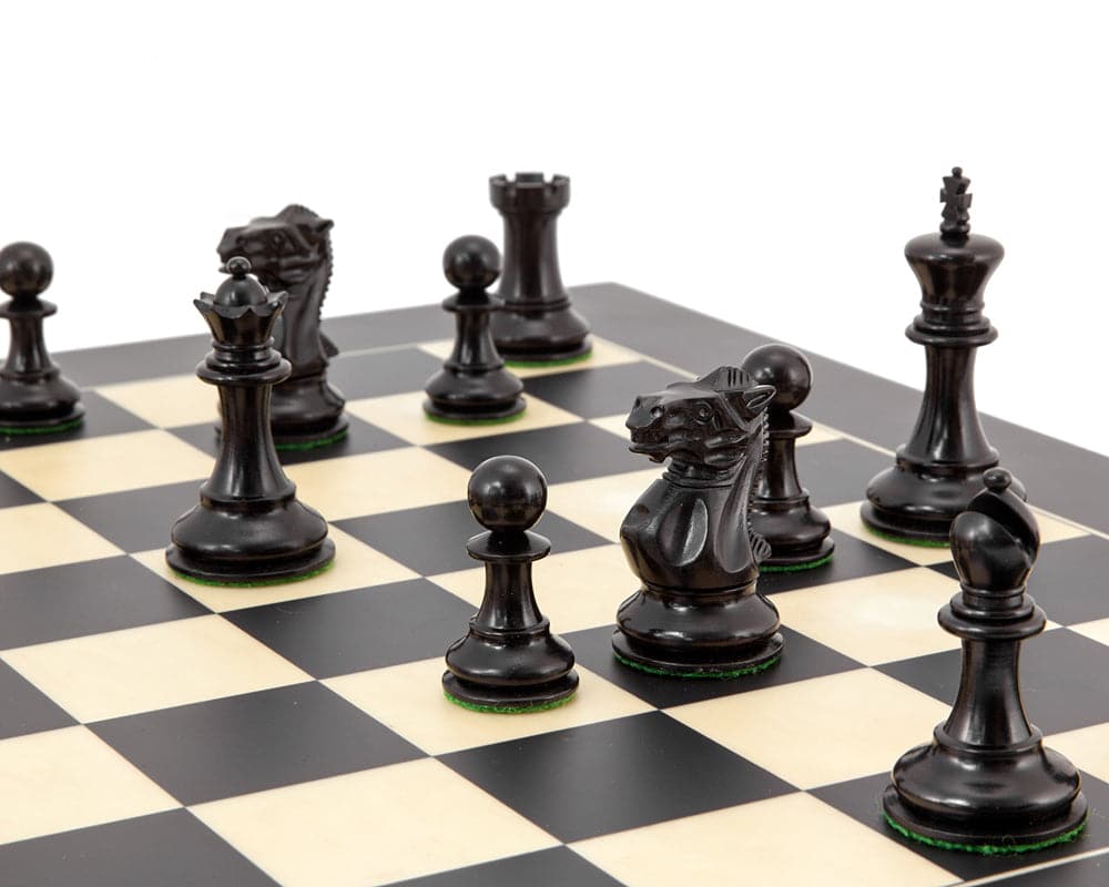 Highgrove Series Ebony Staunton Chess Pieces on chess board with classic Staunton design, featuring 3 inch king and intricately carved knight.