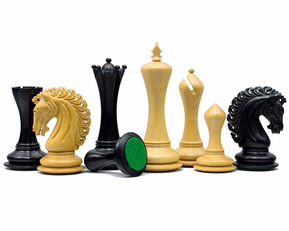 The Empire Knight Ebony Chessmen 4.5 inch set including imperious King, additional Queens, and ornate handcrafted pieces on display.