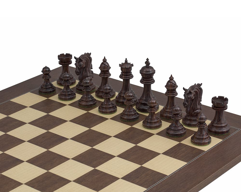 The Kingsgate Rosewood Chessmen 4.25 inch displayed on a chessboard, featuring intricately detailed and weighted rosewood pieces with billiard cloth bases.