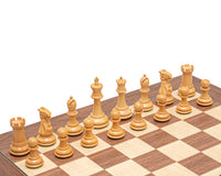Beautifully carved ebonised Staunton chess pieces from the Warwick Series on a chessboard, featuring a 3.25 inch king.