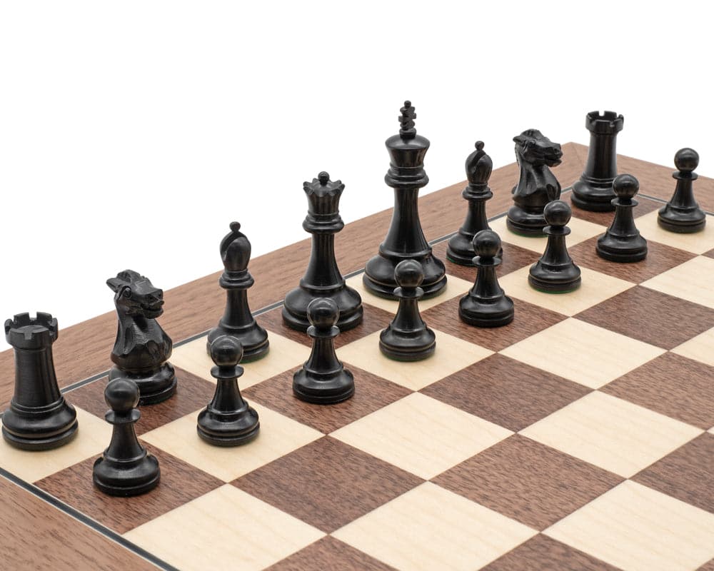 The Coronation Luxury Ebony Miniature Chess Men set displayed on a chessboard.