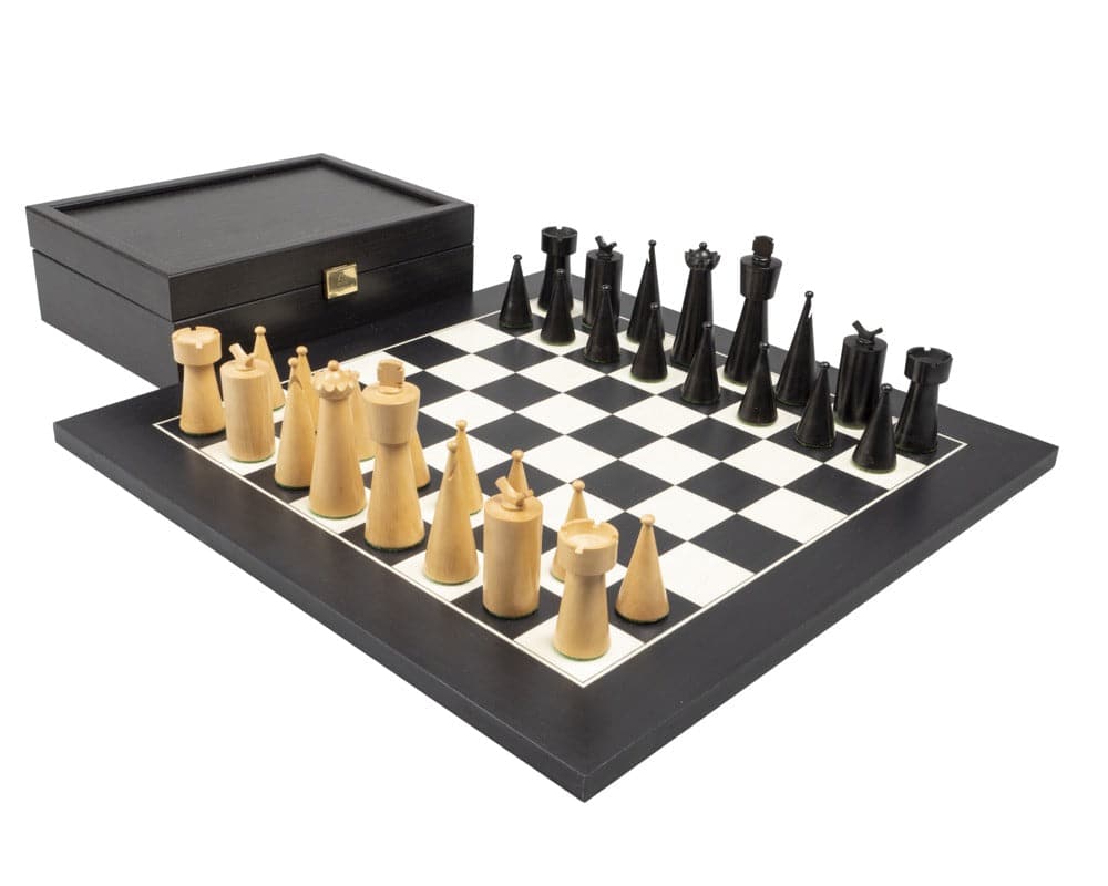 Art Deco Black Chess Set with wooden pieces on a black and white chessboard next to a black storage box.