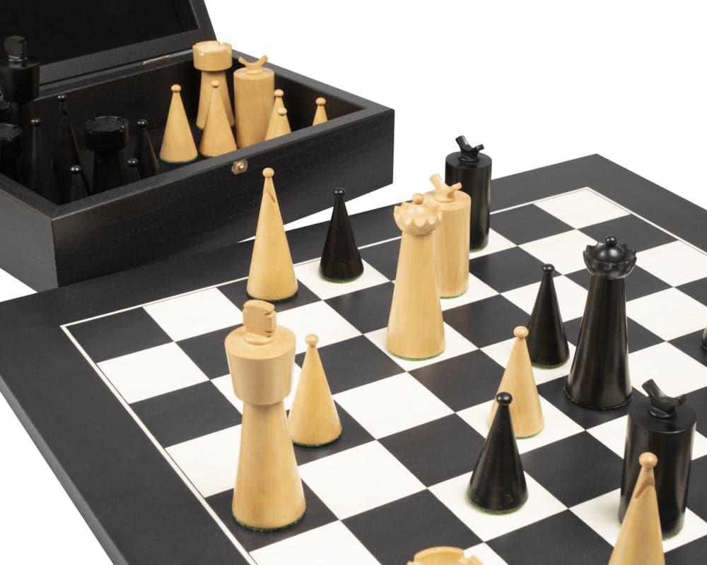 Art Deco Black Chess Set with unique wooden chess pieces and a matching storage box on a black and white chessboard