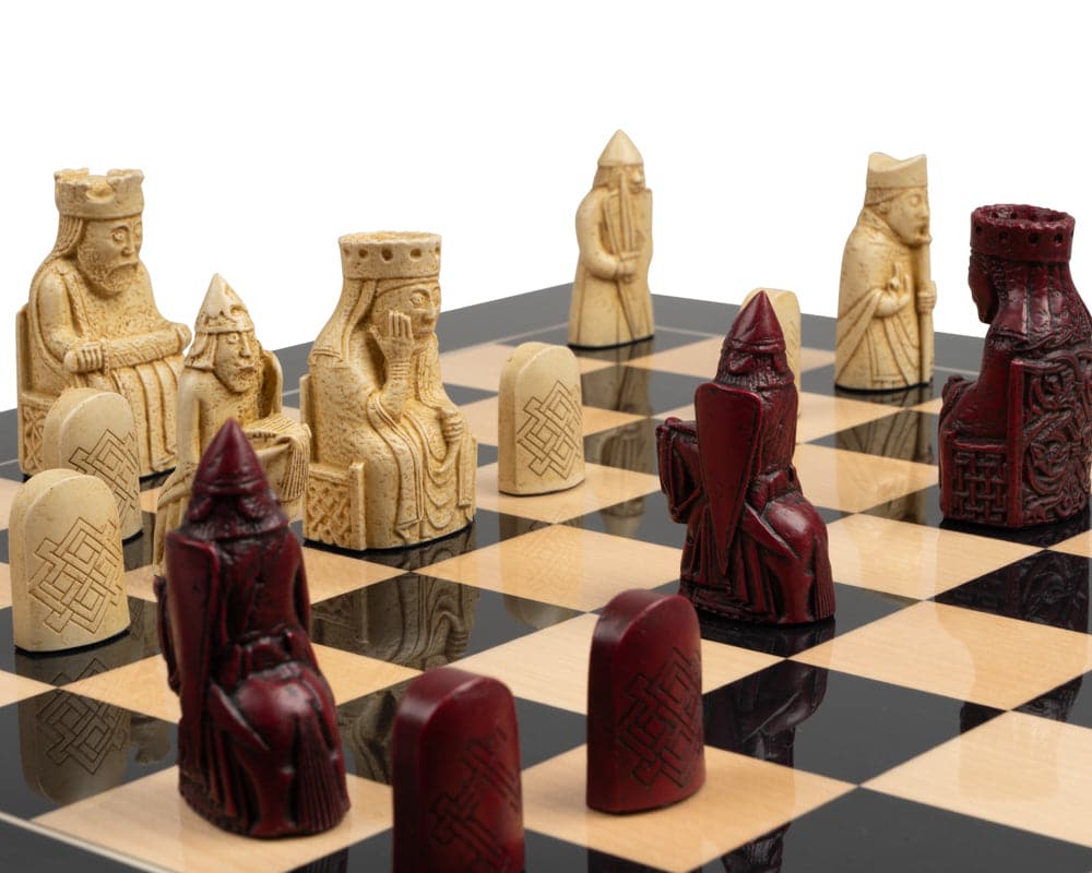 The Isle of Lewis black and red chess set on display on a black and white chessboard