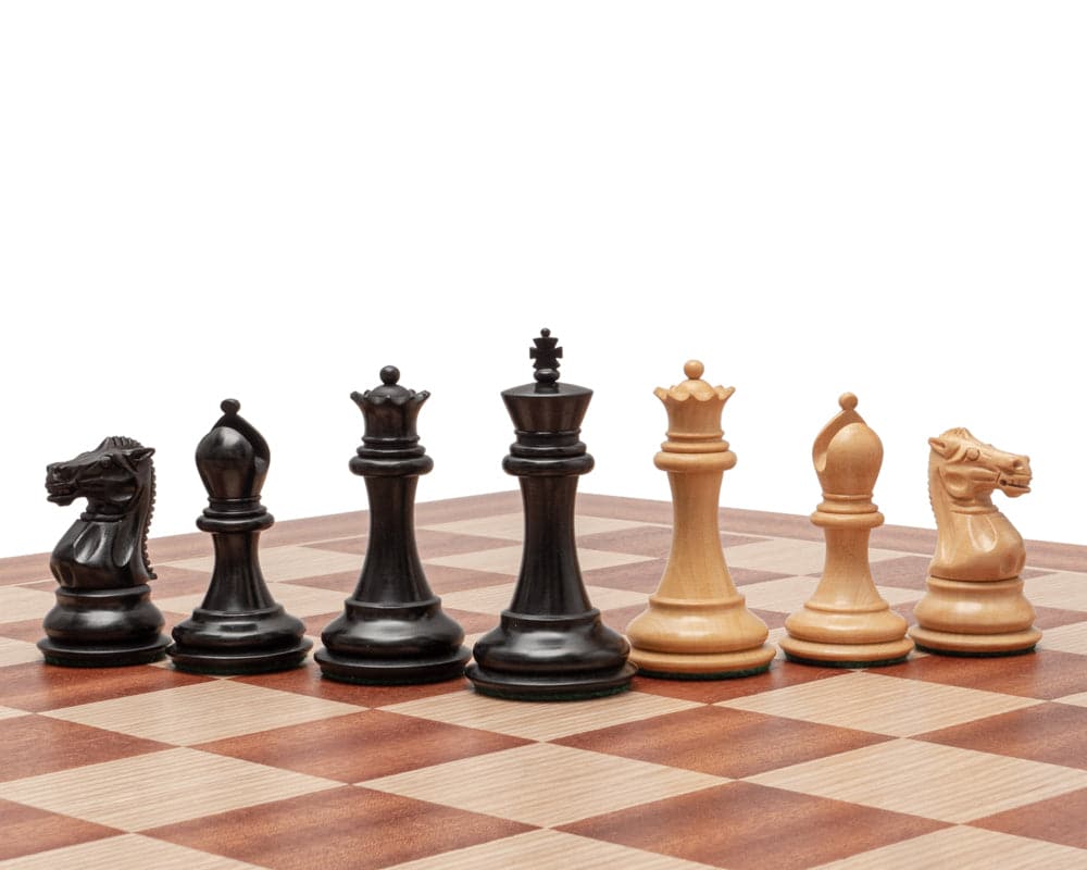 Staunton chess pieces on a mahogany and birch board, featuring ebonised and natural boxwood designs from The Sovereign Black and Mahogany Staunton Chess Set