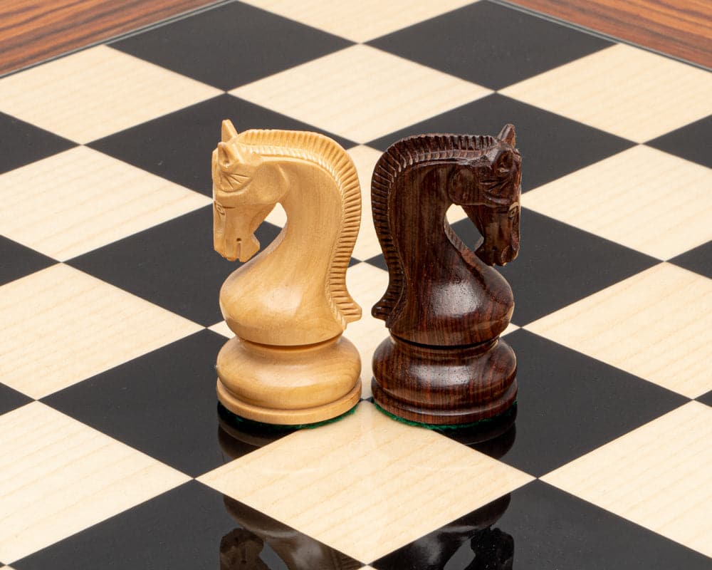 The Leningrad Anjan and Palisander Luxury Chess Set with beautifully crafted wooden knight pieces on a large chessboard with 2.5 inch squares.