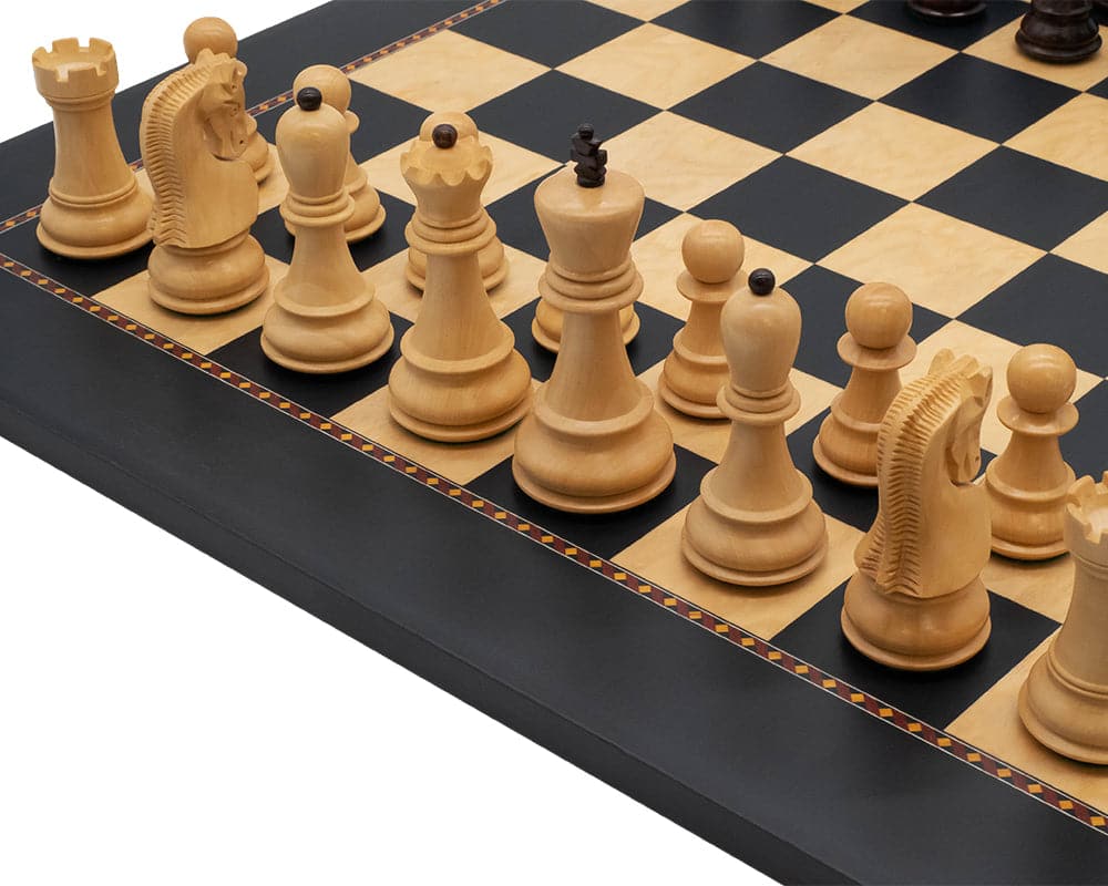 The Queens Gambit chess set on a Rechapados Ferrer board with decorative border.